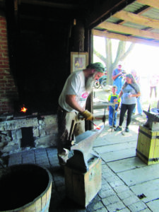 a man working on a hot item over an anvil